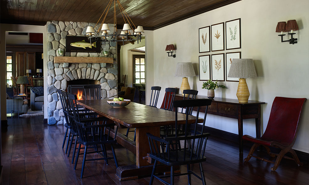 Dining room with fireplace and local art - Eleven Experience's Rio Palena Lodge