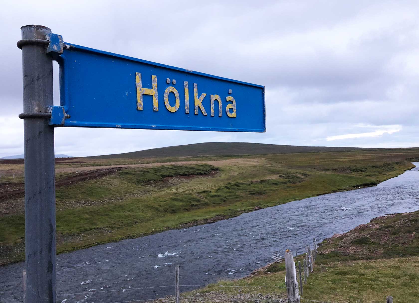 Holkna sign shows over river in Iceland