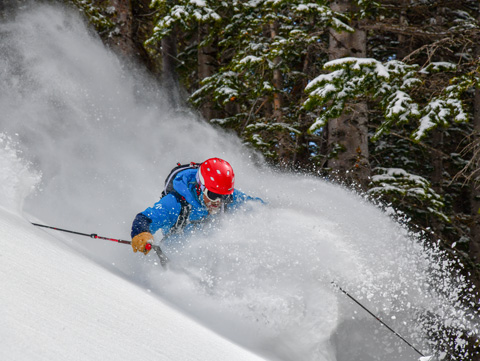 skier makes a turn in deep snow in the colorado backcountry
