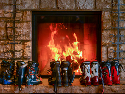 ski boots are warmed by the fire
