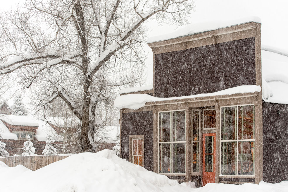 snow falls on the exterior of sopris house